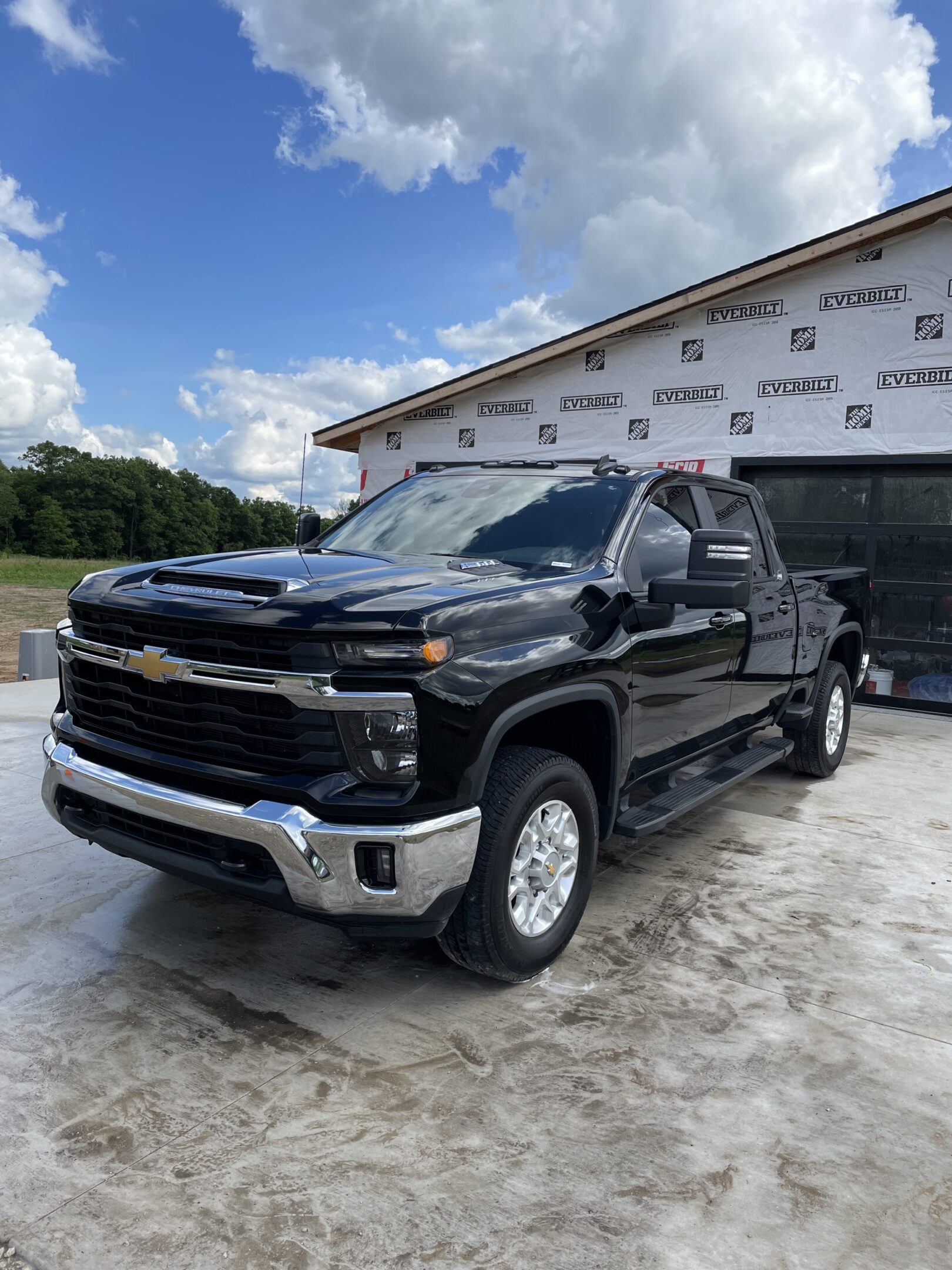 A black truck parked in front of a garage.