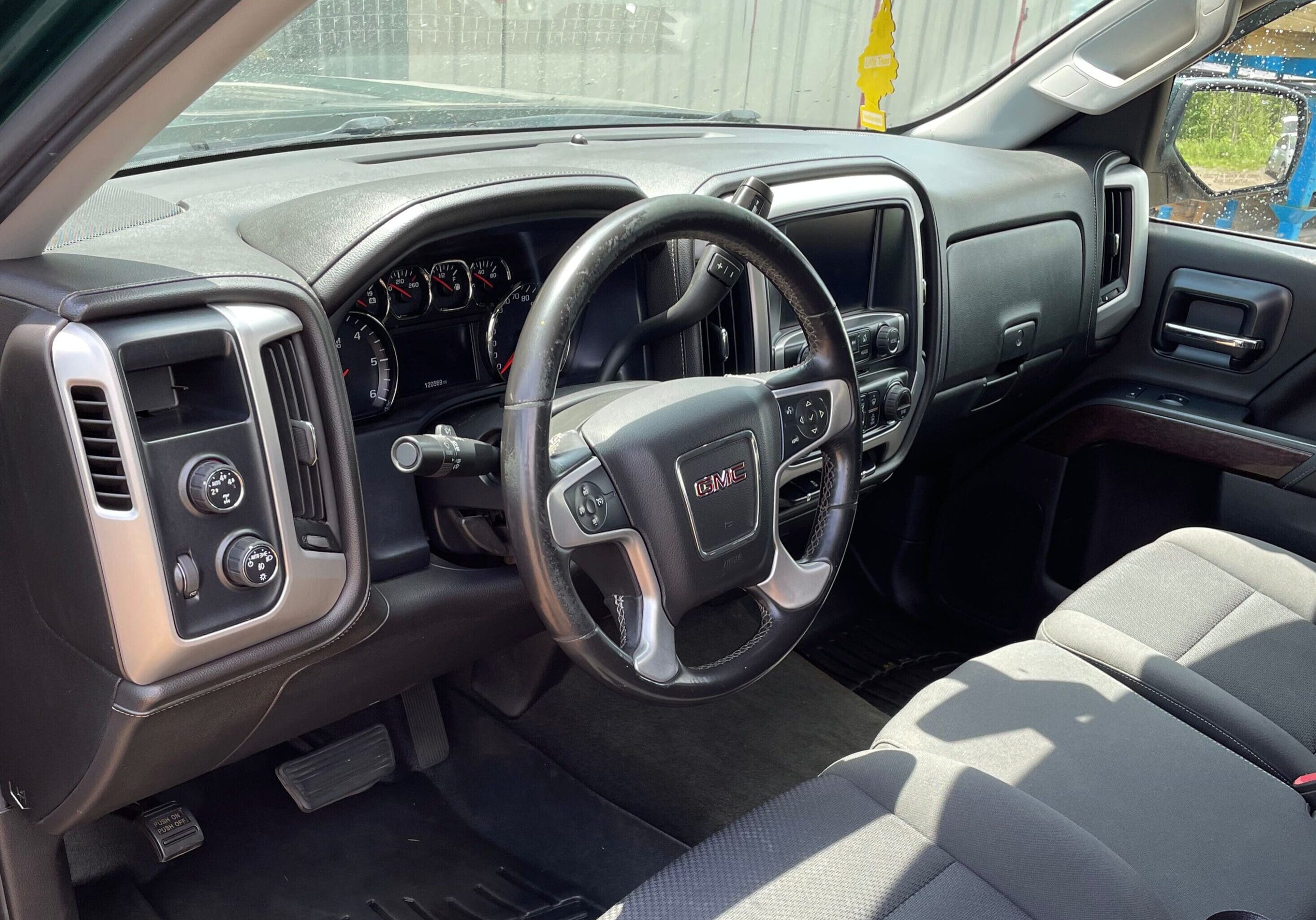 A truck is shown with the dashboard and steering wheel.